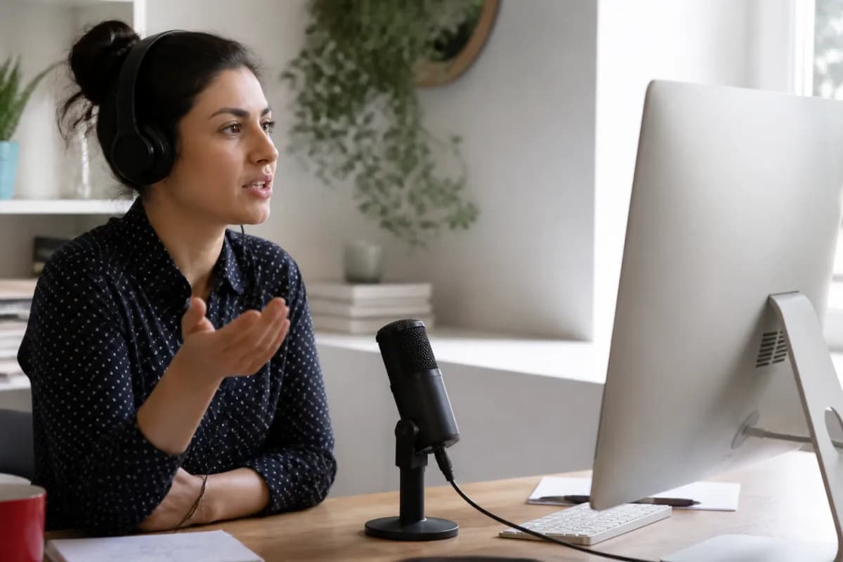 Learner recording an IELTS Speaking practice response at a computer